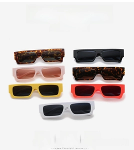 Flat lay of vintage rectangular sunglasses in multiple colors with thick frames