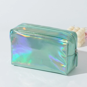 Macro detail of holographic mint green PU cosmetic bag with metallic zipper and iridescence