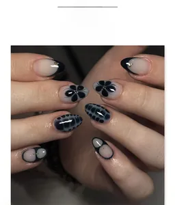 Detail of almond-shaped fake nails with dark blue French tips and floral nail art