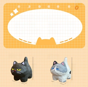 Detailed view of cute resin black and grey cat figurines with wood carving texture