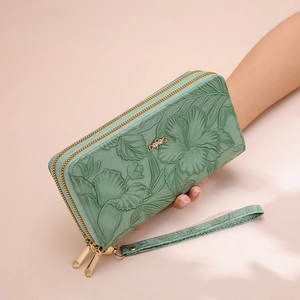Green embossed long wallet with double zipper, floral relief and wristlet strap