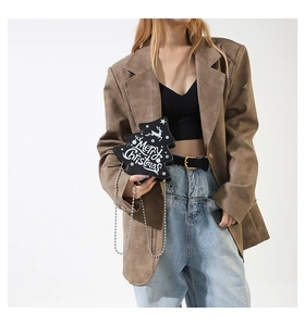 Christmas tree shaped black leather handbag with silver ball chain shown on a model