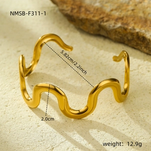 Polished gold wavy stainless steel bangle bracelet with modern open C-shaped design