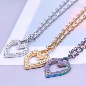 Three-color hollow heart pendants in silver, gold, and rainbow stainless steel finishes