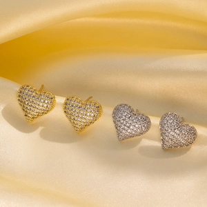 Hip hop heart stud earrings in gold and silver finish with pavé cubic zirconia