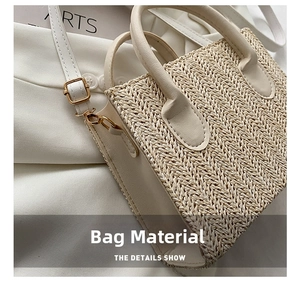 Detail shot of the cream woven fabric texture and premium golden metal hardware of the bag