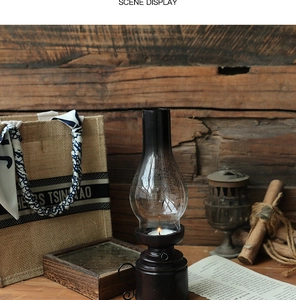 Close-up of vintage resin kerosene lamp candle holder on rustic wooden surface