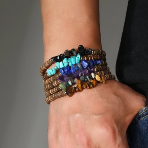 Detail view of multilayer bohemian bracelet featuring natural gemstones and wood beads
