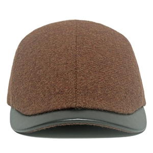 Detail of wool texture and grey leather brim on the brown retro winter beret cap
