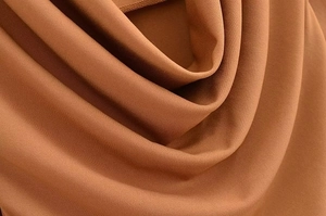 Detail of brown fabric texture and drape of the French style long sleeve dress