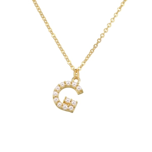 Detailed close-up of a golden letter G pendant necklace inlaid with small white pearls