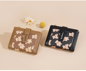 Detail of cross-grain leather wallets with cute bear prints and metal zipper closures