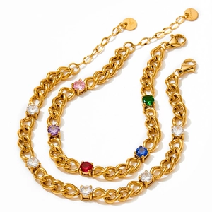 Detailed macro shot of gold-plated stainless steel Cuban chains with multi-colored zircons