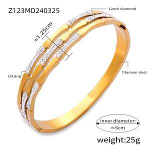 Detail view of 18K gold plated titanium steel bangle with colorful crystals and oil drip finish