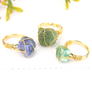 Macro detail of handmade wire wrapped rings featuring irregular natural agate stones