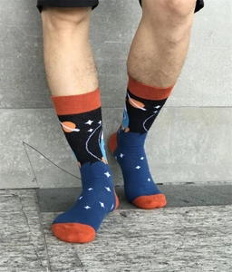 Detailed close-up of astronaut rocket space pattern crew socks in orange and blue