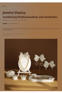 Detail of elegant plaster jewelry display stands with pearl necklaces and gold rings