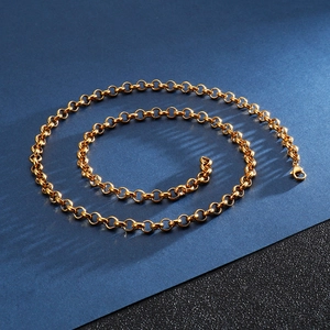 Polished golden stainless steel O-chain necklace displayed in a spiral on dark background