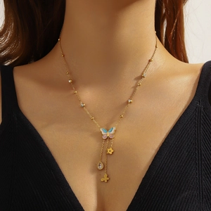 Golden bead necklace with enamel butterfly pendant, flower charm and teardrop gem