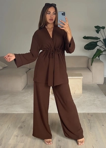 Detail of dark brown long sleeve lace-up top and wide leg pants set with fine texture