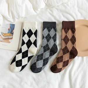 Three pairs of diamond pattern crew socks in black, grey, and brown cotton blend fabric
