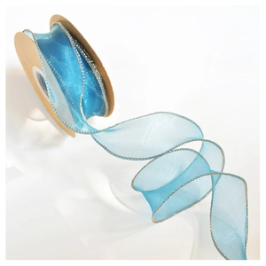 Close-up of light blue organza ribbon with gold metallic edges on a cardboard spool
