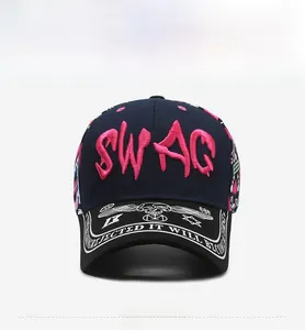 Detail of pink SWAG 3D embroidery and white graffiti print on a navy blue baseball cap
