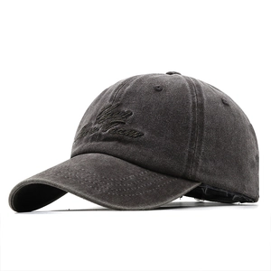 Detailed view of the dark grey washed cotton fabric and Vogue Team embroidery on the cap