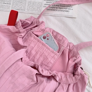 Macro view of the pink pleated tote bag interior showing the functional inner pocket
