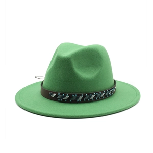 Detail of green wool fedora hat featuring a brown leather band and ethnic beaded accents