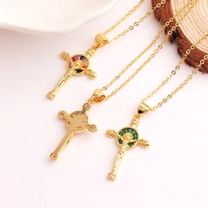 Three 18K gold plated cross necklaces with colorful zircon halos on white ceramic plate