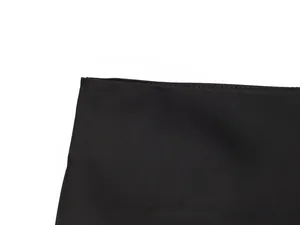 Detail of sewing craftsmanship on black acetate fabric with neat stitching edges