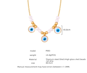 Macro view of gold-plated evil eye pendant with shell inlay and detailed dimensions