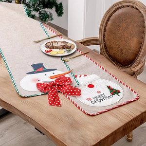 Linen Christmas table runner with Santa and Snowman embroidery on wood table