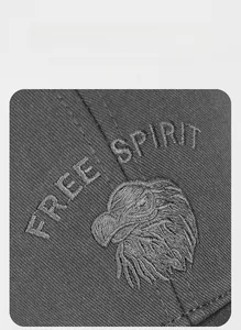 Detail of Free Spirit eagle embroidery on premium dark grey cotton baseball cap