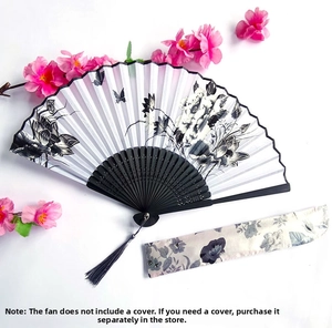 Detail of Chinese folding fan featuring black lotus print with grey silk tassel on black frame