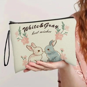 Off-white canvas makeup bag with cute cartoon rabbits and a portable black wrist strap