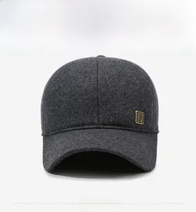 Detail of dark gray baseball cap with wool texture and a side square metal logo