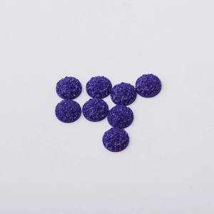 Macro view of 12mm purple resin cabochons with sparkling druzy crystal texture