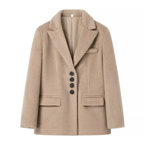 Detailed flat lay of a camel faux fur blazer with four buttons and plush texture