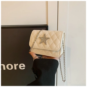 Detail of white quilted crossbody bag for kids with rhinestone star and chain strap