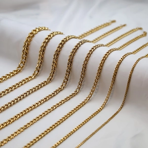 Detailed comparison of eight sizes of golden Cuban link necklaces on white background