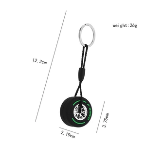 Mini soft rubber tire keychain with silver metal ring and green P ZERO lettering
