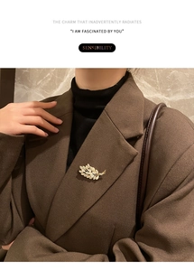 Detail of golden opal wheat ear brooch with sparkling crystals on a blazer lapel