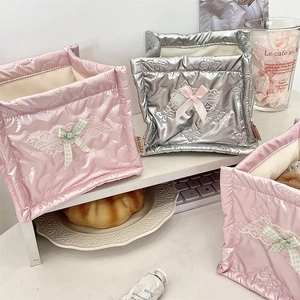 Close-up of quilted bow storage basket featuring satin finish and lace detail in pink and silver