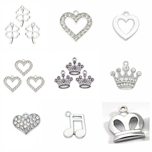 Macro shot of silver alloy DIY charms with rhinestones in clover and crown shapes