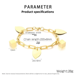 Detail of gold stainless steel geometric chain bracelet with heart and cube pendants