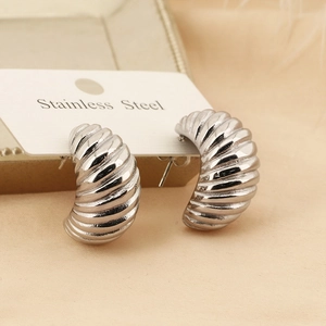 Detail shot of silver stainless steel earrings with unique spiral horn texture patterns