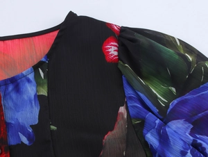 Detail of round neckline and floral chiffon fabric on a black short-sleeved top