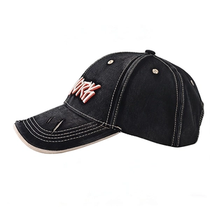 Close-up of distressed black baseball cap with 3D white New York embroidery and ripped brim